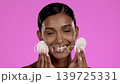 Beauty, skincare and Indian woman with cotton pads in studio, cleansing cosmetics isolated on pink background. Natural makeup, dermatology and skin care model with spa or salon detox facial cleaning 139725331