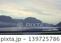 Atmospheric View of Skjolden Fjord with Low Fog and Mountain Silhouettes 139725786