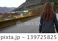 Woman Walking Through Quiet Mountain Village in Norway 139725825