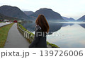 Woman Walking Along Scenic Fjord Path in Skjolden Norway 139726006