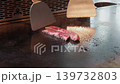 A close-up video of a teppanyaki chef's steak grill, with steam rising. 139732803