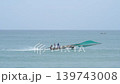 Fishermen navigate a traditional Thai boat while poaching in the sea. They haul in nets in search of fish along the coastline during their journey. High quality 4k footage 139743008