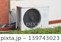 The air conditioner cooling unit is at the back of the house. A fan cools the radiator of an air conditioner in a hot climate in Asia. Reliability and maintenance of air conditioners in Thailand. High 139743023