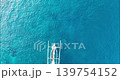 Top Down Drone View of Traditional Jukung Boat on Turquoise Ocean in Bali 139754152