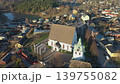 Porvoo.Finland-December 12.2020: Closer aerial shot of the historical Evangelical Lutheran Church in Porvoo Finland with green forest in the background. Drone turning around the church. 139755082