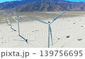Wide aerial panorama of windmills across Palm Springs desert landscape with mountains and dry terrain scenery 139756695