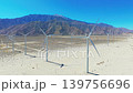 Aerial drone view of wind turbines with mountain backdrop in Palm Springs California desert environment 139756696