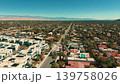 Aerial drone panorama of Palm Springs California with desert city streets residential homes and mountain backdrop 139758026