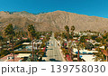 Aerial view of residential Palm Springs neighborhood with palm trees streets and mountains in desert California 139758030