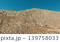 Drone aerial of rugged mountain ridge above Palm Springs desert landscape with rocky textures and blue sky 139758033