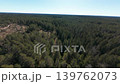 Cinematic FPV drone flight over dense boreal forest and rocky wilderness terrain in Nuuksio, Finland during early spring. 139762073