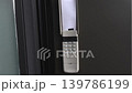 Wall-mounted intercom system with paper insert visible, showcasing buttons and design in a modern indoor setting 139786199