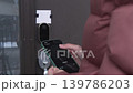Person using smartphone to unlock smart door lock, showing progression from initiating to unlocking action at an entrance 139786203