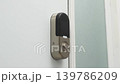 Smart door lock mechanism shown in three frames, highlighting the gradual unlocking process on a white door with a light blue wall background 139786209