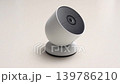 Modern security camera positioned on a smooth surface, showcasing its sleek design and adjustable angle for optimal surveillance coverage in a contemporary setting 139786210