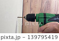 electric drill rasping and humming when drilling a cement wall 139795419