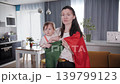 Young mother and baby wrapped in national flag emotionally supporting football team at home 139799123