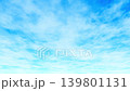A video of clouds drifting across a blue sky. (Loop) 139801131