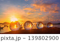 Beneath the relentless sun, the tools of a soldier journey rest on desert ground, capturing the beauty of silence and the lasting mark of human courage. Symbols of Courage on the Sands of Time 139802900