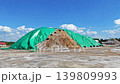 Huge sand-salt pile for winter road maintenance covered with green PVC film 139809993