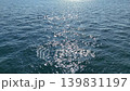 4K Drone shot of sparkling sun glares reflecting on dark blue ocean waves 139831197