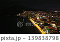 Vibrant seaside boulevard at night, aerial view of busy waterfront with glowing hotel signs and neon 139838798