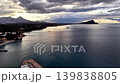 Moody sunset over coastal bay and mountains, aerial twilight panorama with dramatic clouds, calm reflective 139838805