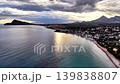 Sunrise aerial coastline with calm turquoise sea, sun reflection on water near sandy bay, dramatic cloudscape 139838807