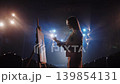 Female painter creating artwork under dramatic cinematic lighting 139854131