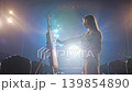 Active Side View of Female Artist Making Brush Stroke on Easel Stage 139854890