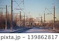 Russia, Peterhof, railway tracks on a sunny winter day, poles for electric lines along the tracks for electric trains, railway crossing 139862817