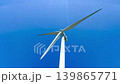 Wind Turbine Standing Tall Against Clear Blue Sky 139865771