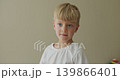 Portrait caucasian happy satisfied little boy positive child cute kid looking at camera make thumb up 139866401
