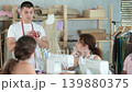Tailoring instructor demonstrating garment construction in adult sewing class  139880375