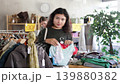 Latin American chooses panties from a lingerie store. Latin customer stands in front of a clothing stand and picks out a set of underwear 139880382