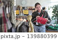 Young woman choosing handbag in clothing store 139880399