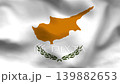 Cyprus flag on wavy fabric, top view. Realistic white textile featuring the copper island map and green olive branches. 139882653