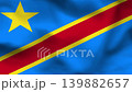Republic of the Congo flag on wavy fabric, top view. Realistic textile with green, yellow, and red diagonal stripes. 139882657