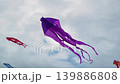 Colorful kites are flying in the cloudy sky during summer outdoor festival 139886808