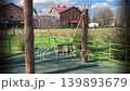 Empty children's swings in a city park. 139893679