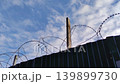 Prison fence with metal barbed wire 4K video footage 139899730