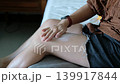 Asian female using body lotion on smooth legs, wellness and self care lifestyle theme 139917844