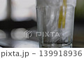 Pouring Fresh Water Into A Glass With Ice Cubes. Close up of clear liquid filling a crystal tumbler with frozen blocks, suitable for healthy lifestyle commercials or refreshing beverage advertisements 139918936