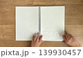 A child's hand closing a large ring notebook in 4K slow motion. 139930457