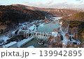 A panoramic view of the snow-covered Shimizusawa Dam in Yubari City, Hokkaido, at dusk. 139942895