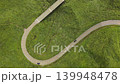 Aerial footage of a hairpin-curve road winding through the green forests of Minami Aso, Kumamoto Prefecture. 139948478