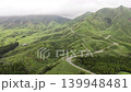 Aerial footage of winding mountain roads through the lush green mountainous region of Minami-Aso, Kumamoto Prefecture. 139948481