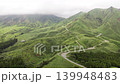 Aerial footage of winding mountain roads through the lush green mountainous region of Minami-Aso, Kumamoto Prefecture. 139948483