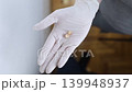 Pediatric dentist in white gloves holding extracted primary milk teeth. Concept of deciduous tooth loss, dental extraction procedure and childhood healthcare. Pediatric dentist in white gloves holding extracted primary milk teeth. Concept of deciduous tooth loss, dental extraction procedure and childhood healthcare. 139948937