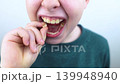 10 year old boy at pediatric dentist showing milk tooth extraction. Concept of caries treatment, physiological change of teeth and permanent teeth eruption in school age children. 10 year old boy at pediatric dentist showing milk tooth extraction. Concept of caries treatment, physiological change of teeth and permanent teeth eruption in school age children. 139948940